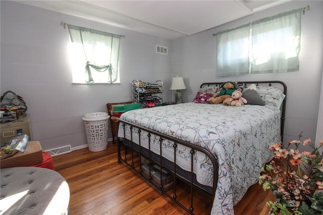 bedroom featuring wood-type flooring and multiple windows