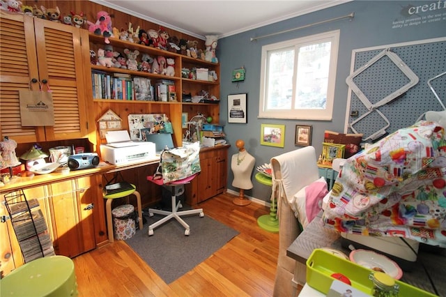 office space with light wood-type flooring and ornamental molding