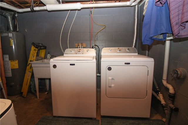 laundry area with sink, washer and dryer, and gas water heater