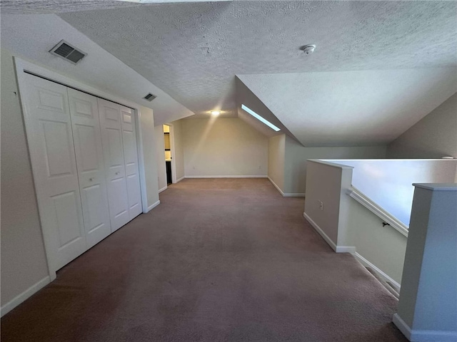 bonus room featuring carpet flooring, a textured ceiling, and lofted ceiling