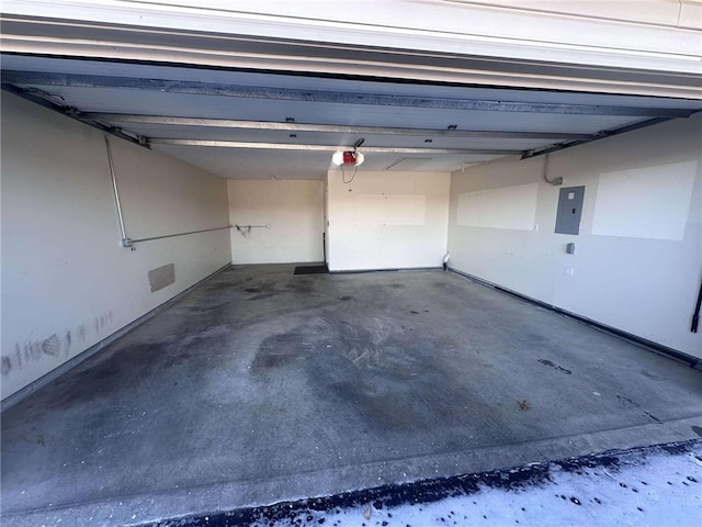 garage featuring electric panel and a garage door opener