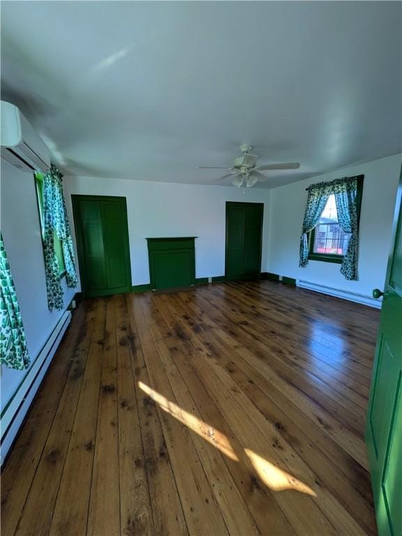 additional living space featuring dark hardwood / wood-style flooring, baseboard heating, and a wall mounted AC