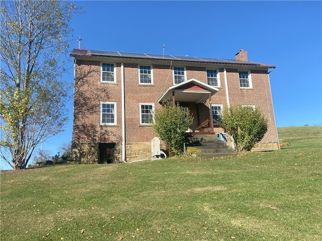 rear view of property with a yard