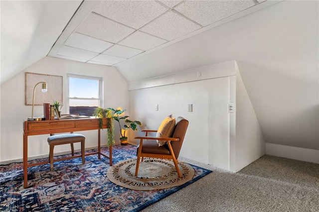 office space with a paneled ceiling, carpet floors, and vaulted ceiling