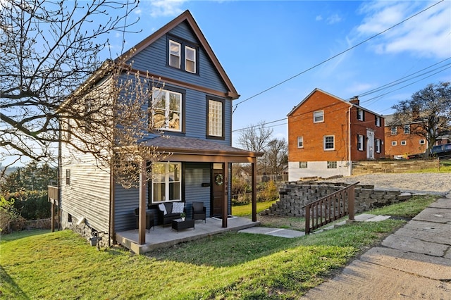 back of house featuring a porch and a yard