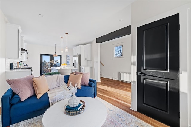 living room with light hardwood / wood-style flooring and radiator