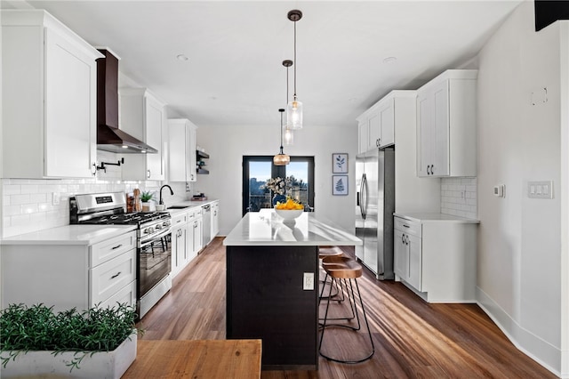 1940 Warriors Rd, Banksville/Westwood, PA 15205 - kitchen featuring stainless steel appliances, wall chimney exhaust hood, a center island, backsplash, and light countertops