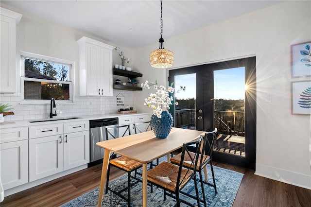 dining space featuring french doors, dark wood-type flooring, and sink