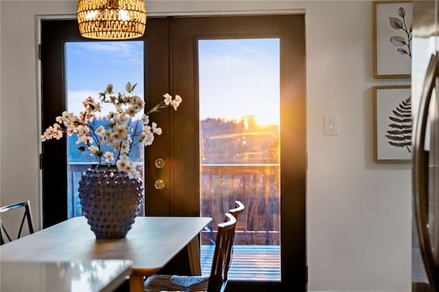 dining space with french doors and a notable chandelier