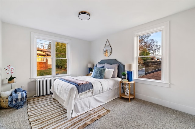 carpeted bedroom featuring radiator and multiple windows