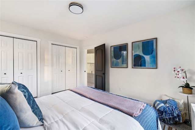 bedroom featuring carpet flooring and two closets