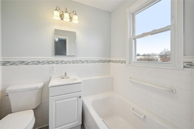 bathroom with a bathtub, toilet, tile walls, and vanity