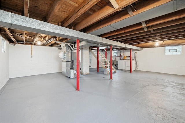 basement with heating unit and washer and dryer