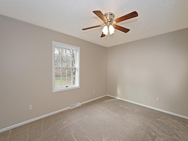 unfurnished room featuring ceiling fan, carpet, and a textured ceiling