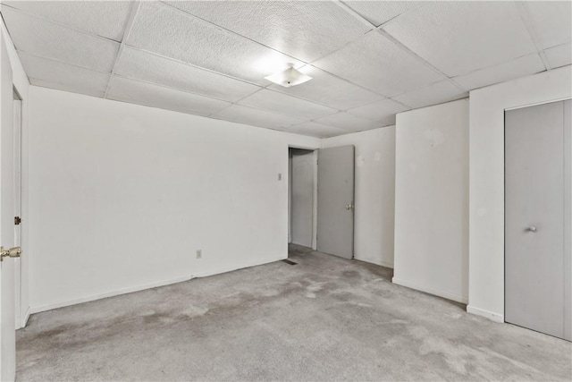 interior space with light carpet and a drop ceiling