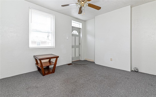 carpeted foyer with ceiling fan