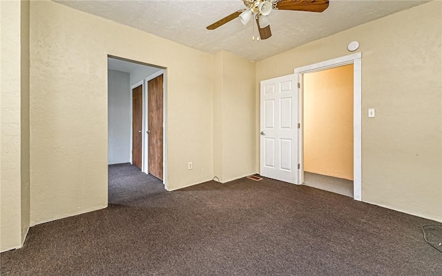 carpeted empty room with a textured ceiling and ceiling fan