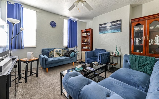 carpeted living room with ceiling fan and a textured ceiling