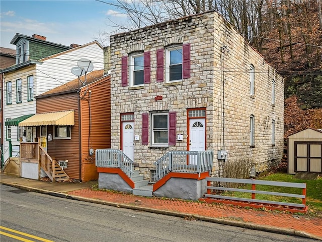 view of front facade with a storage shed