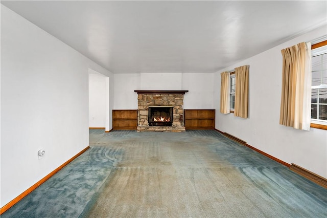 unfurnished living room featuring a fireplace and carpet