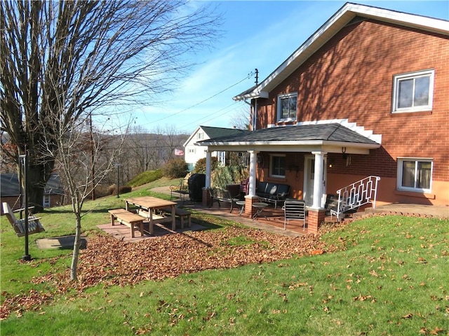 rear view of house with a yard and a patio