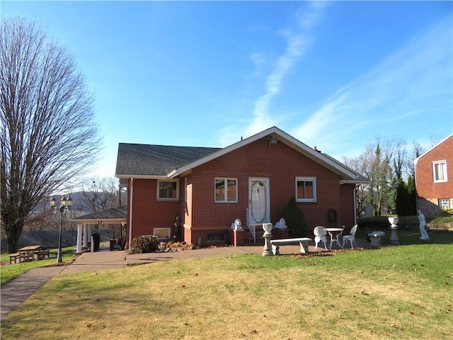 back of property featuring a yard and a patio