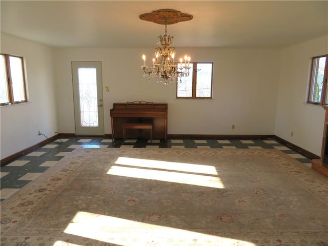 unfurnished room with a wealth of natural light and a chandelier