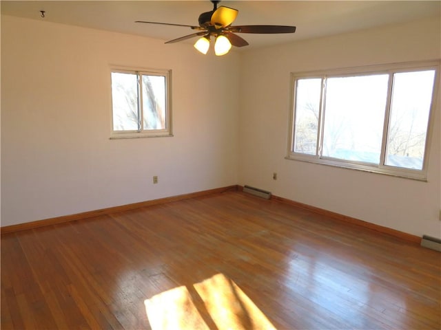 spare room with hardwood / wood-style floors and ceiling fan