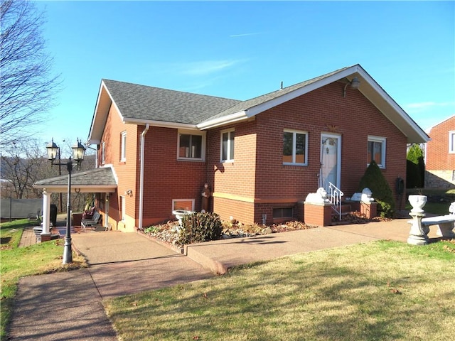 back of house with a lawn