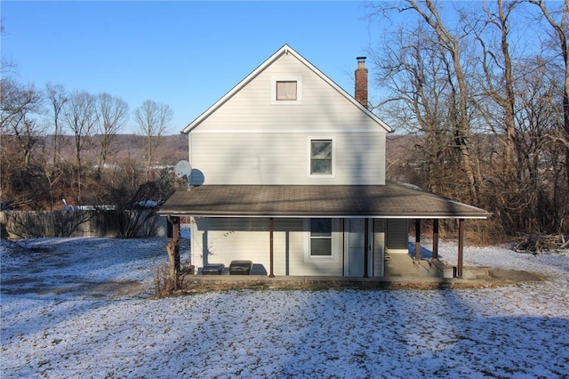 snow covered property with a patio