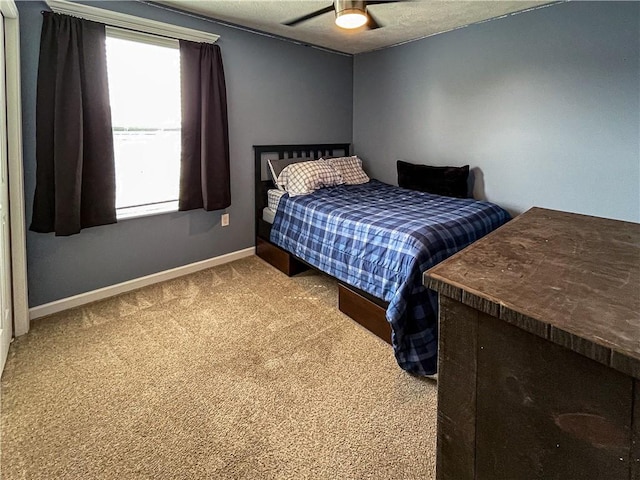 bedroom with ceiling fan and carpet floors