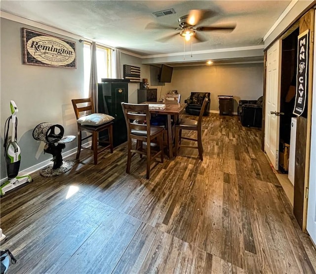 dining area with ceiling fan, dark hardwood / wood-style flooring, and ornamental molding