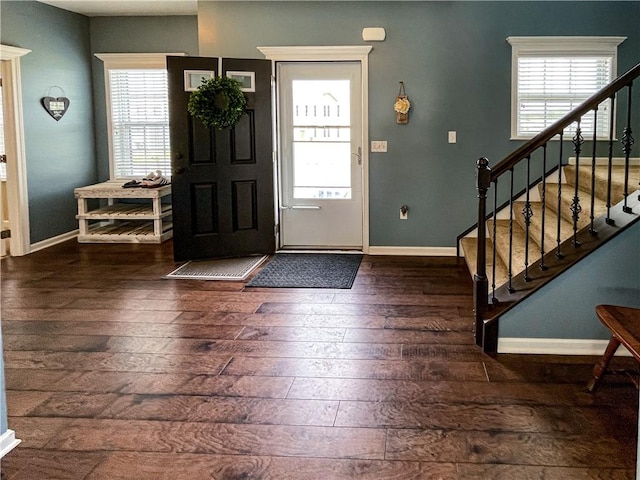 entryway with a wealth of natural light and dark hardwood / wood-style floors