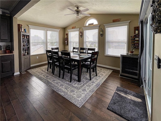 dining room with a textured ceiling, dark hardwood / wood-style floors, vaulted ceiling, and ceiling fan