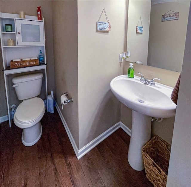 bathroom featuring hardwood / wood-style floors and toilet