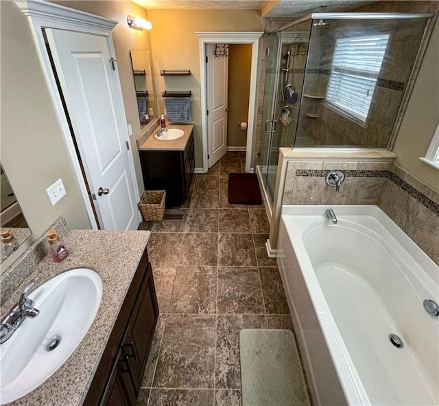 bathroom with vanity and separate shower and tub