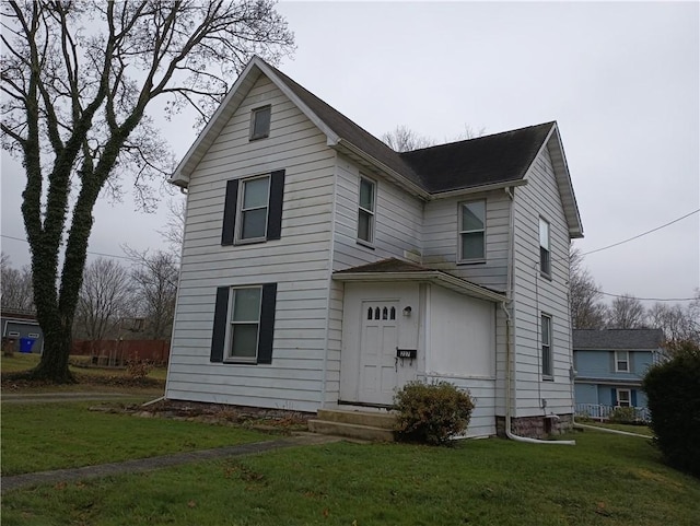 view of property featuring a front lawn