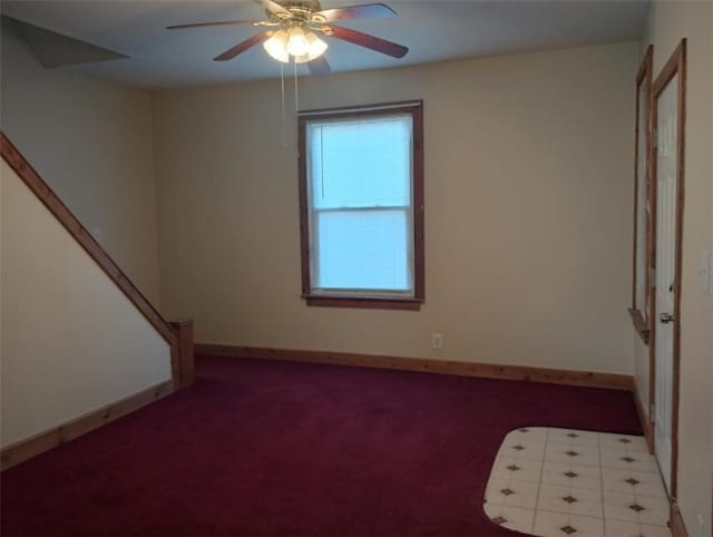 carpeted empty room featuring ceiling fan