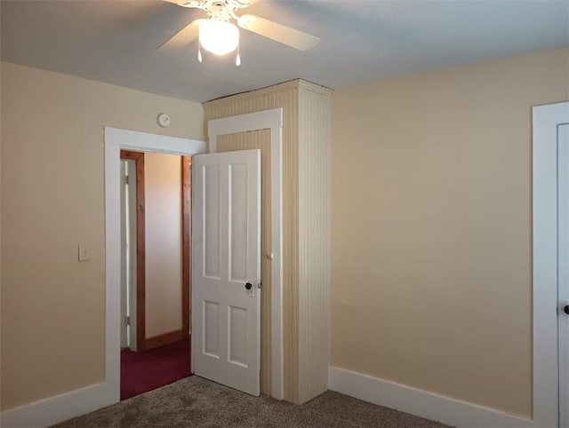 interior space with carpet floors and ceiling fan