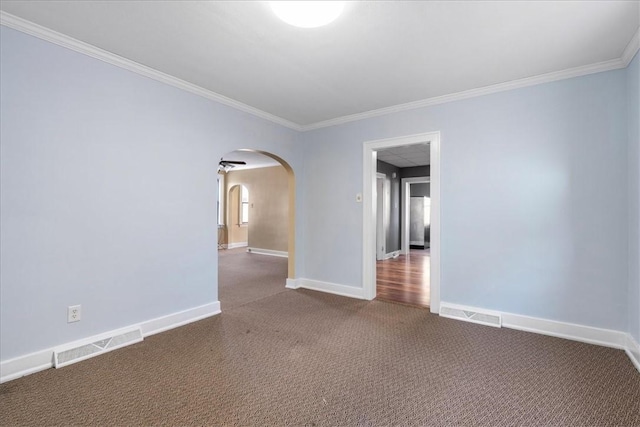 spare room with dark carpet and ornamental molding