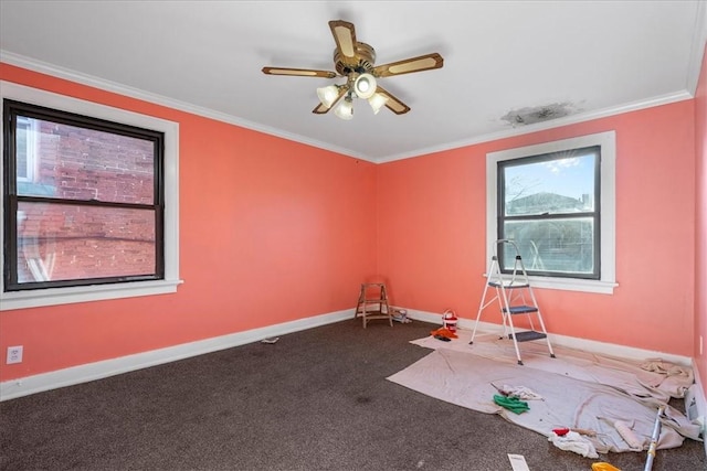 carpeted spare room with ceiling fan and ornamental molding