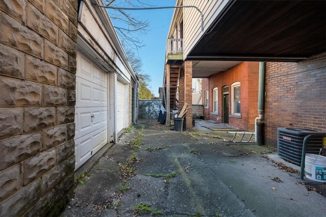 view of home's exterior with a garage and central air condition unit