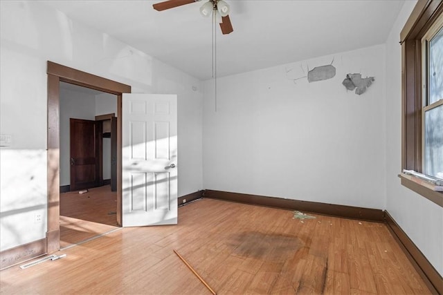 empty room featuring hardwood / wood-style flooring and ceiling fan