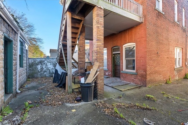 view of side of home featuring a balcony