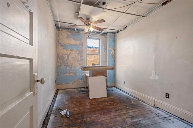 unfurnished room with ceiling fan and dark hardwood / wood-style flooring