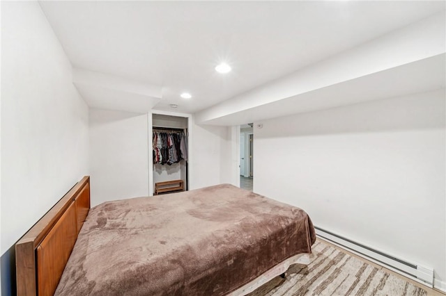 bedroom featuring a closet and baseboard heating