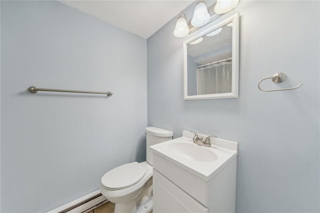 bathroom with a baseboard radiator, vanity, and toilet