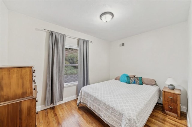 bedroom with hardwood / wood-style flooring