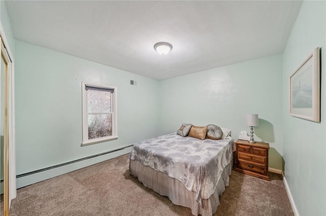 carpeted bedroom featuring a baseboard heating unit