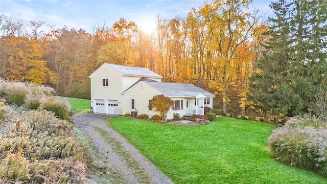 view of front facade featuring central AC, a front lawn, and a garage